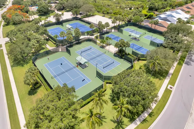 a kitchen with kitchen island white cabinets and refrigerator