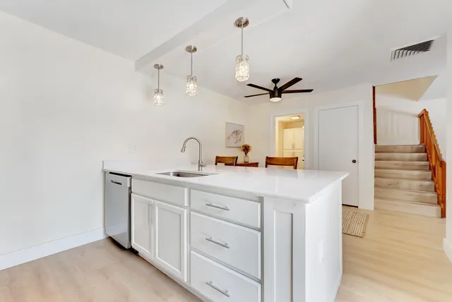 a kitchen with stainless steel appliances white cabinets white stove a microwave and a refrigerator