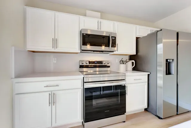 a view of a livingroom with furniture and a flat screen tv
