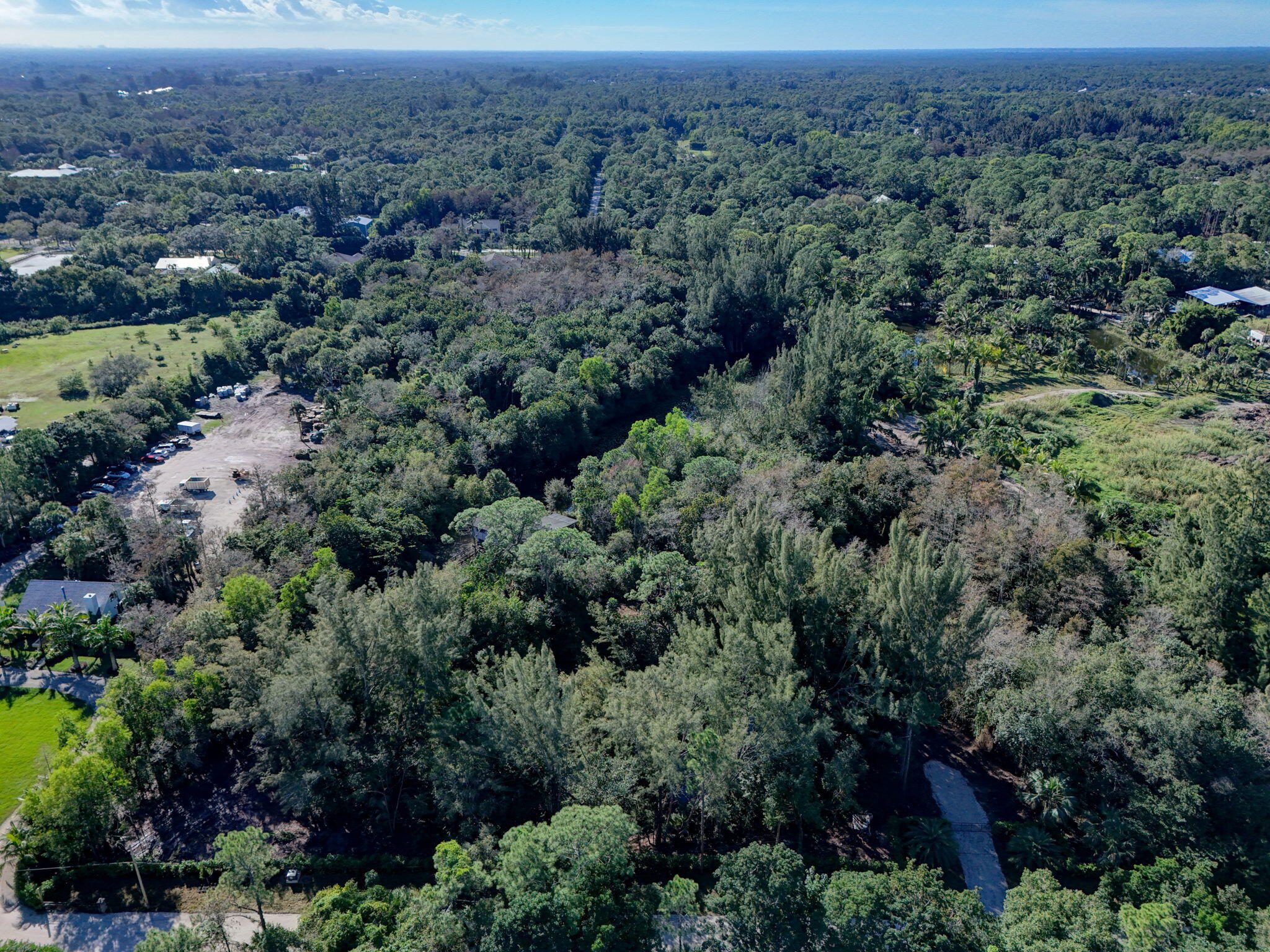 9620 171st Street North Jupiter, FL 33478 - Photo 18 of 23 an aerial view of residential house with outdoor space and trees all around