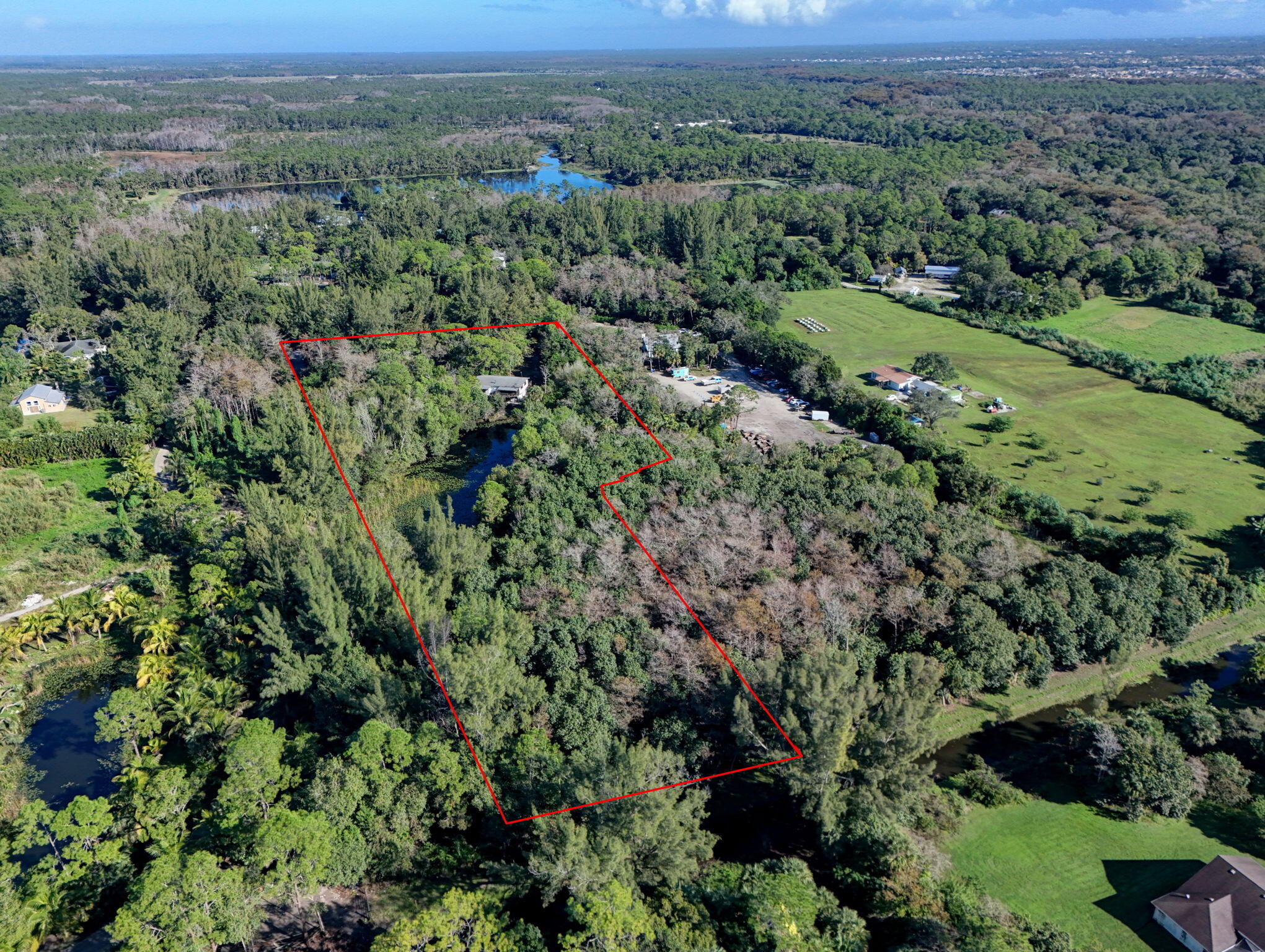 9620 171st Street North Jupiter, FL 33478 - Photo 7 of 23 an aerial view of green landscape with trees houses and mountain view