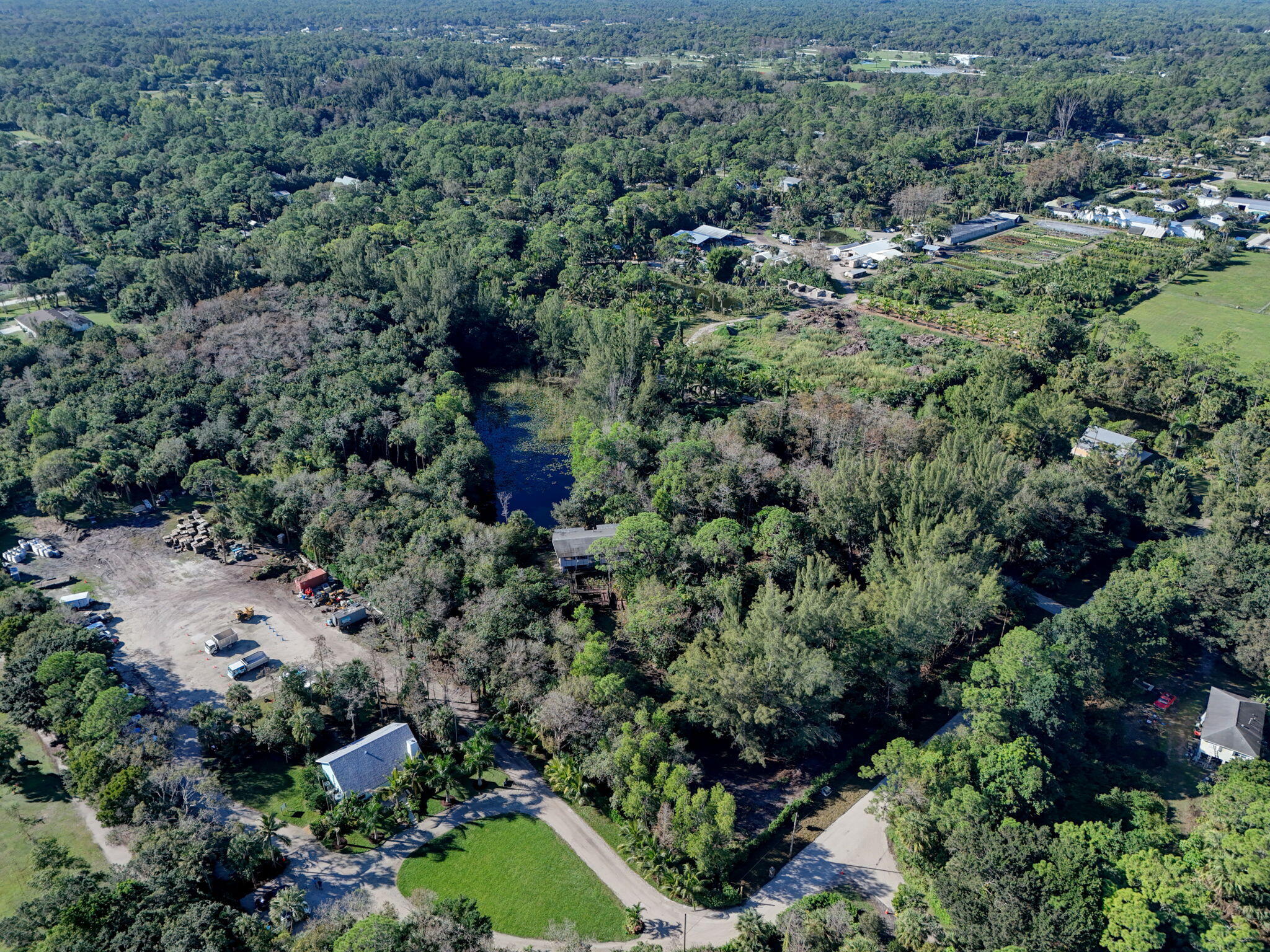 9620 171st Street North Jupiter, FL 33478 - Photo 9 of 23 an aerial view of residential house with outdoor space and trees all around