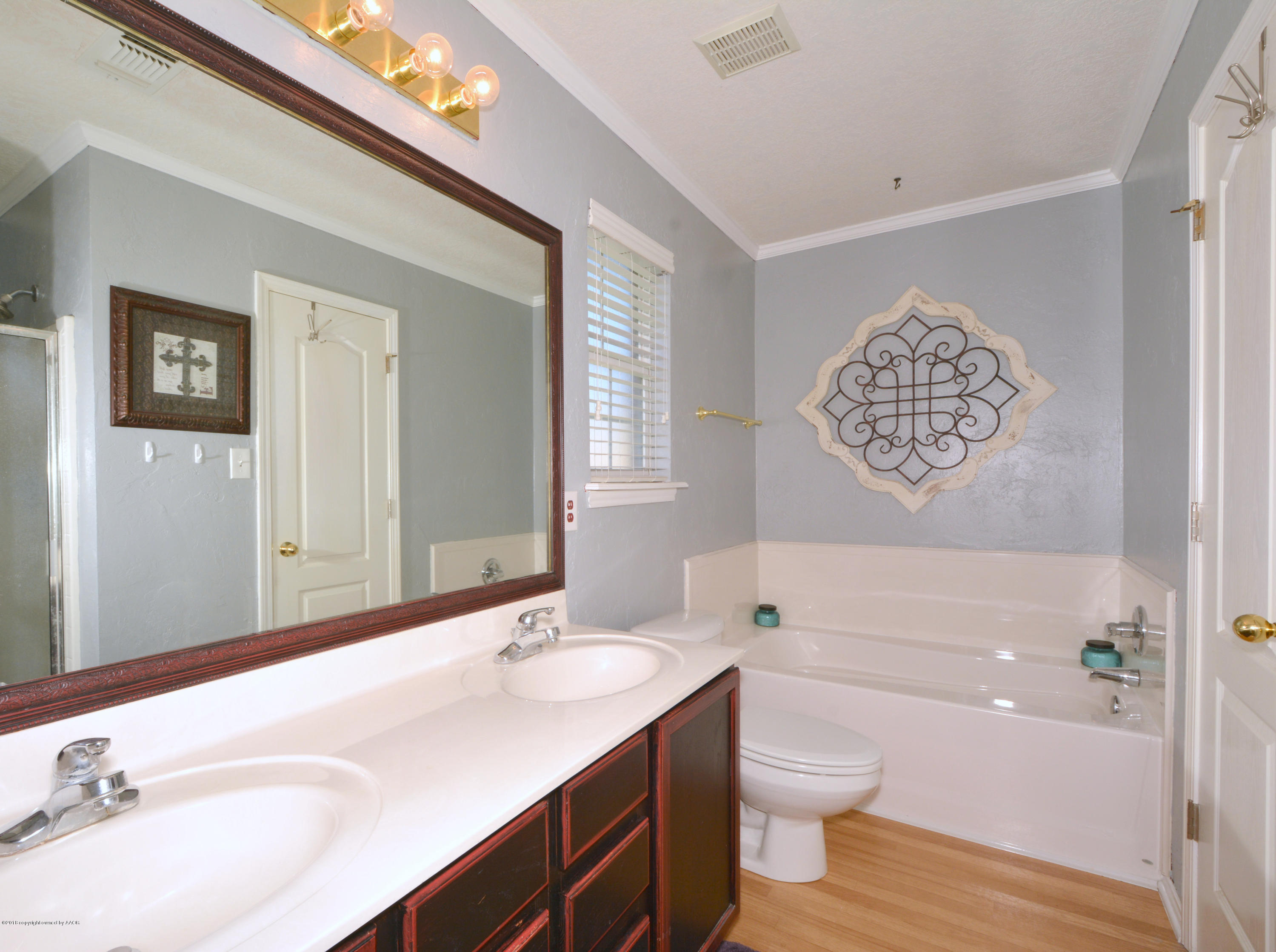 4702 Capulin Lane Amarillo, TX 79110 - Photo 14 of 24 a bathroom with a sink a toilet and shower