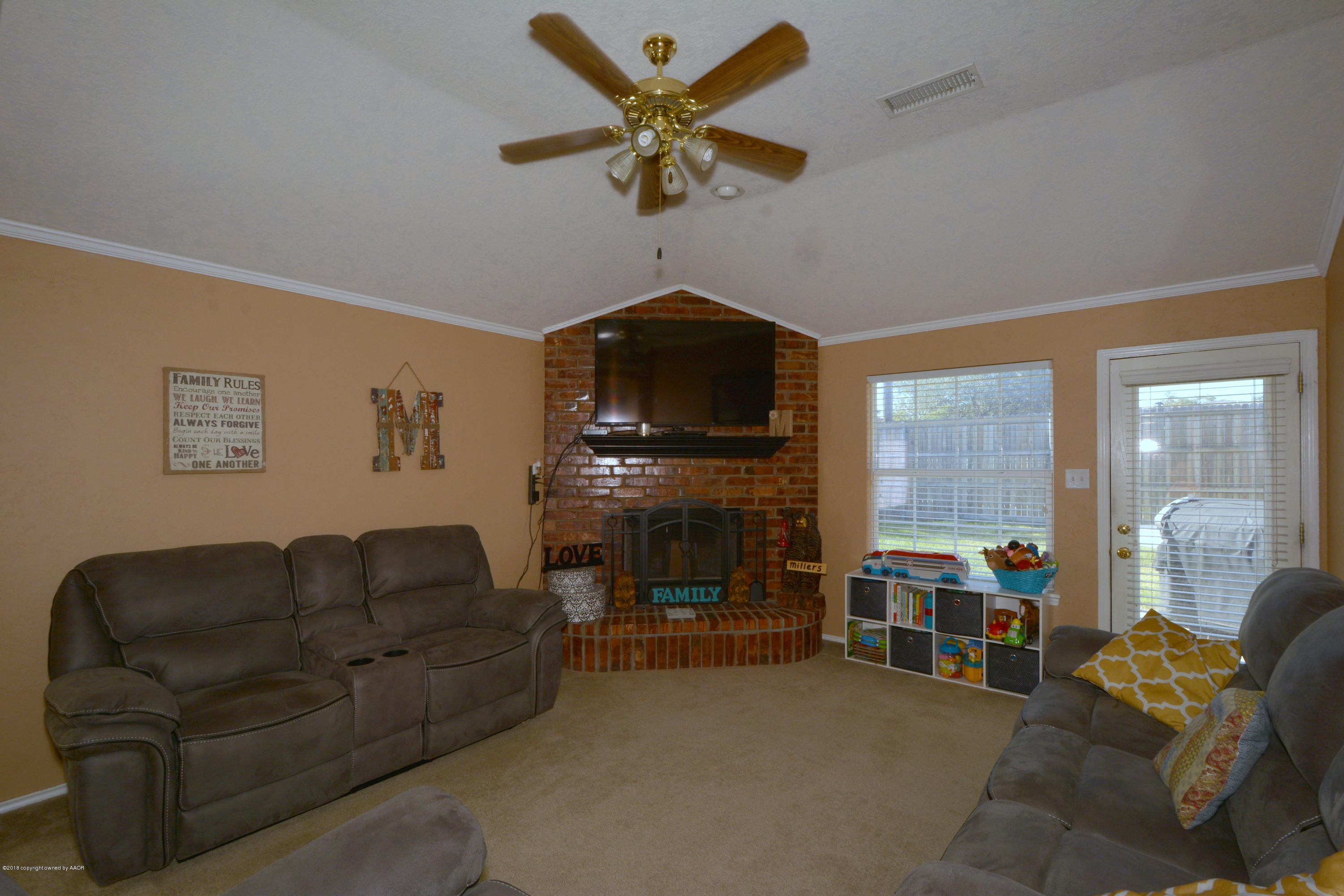 4702 Capulin Lane Amarillo, TX 79110 - Photo 4 of 24 a living room with furniture and a fireplace