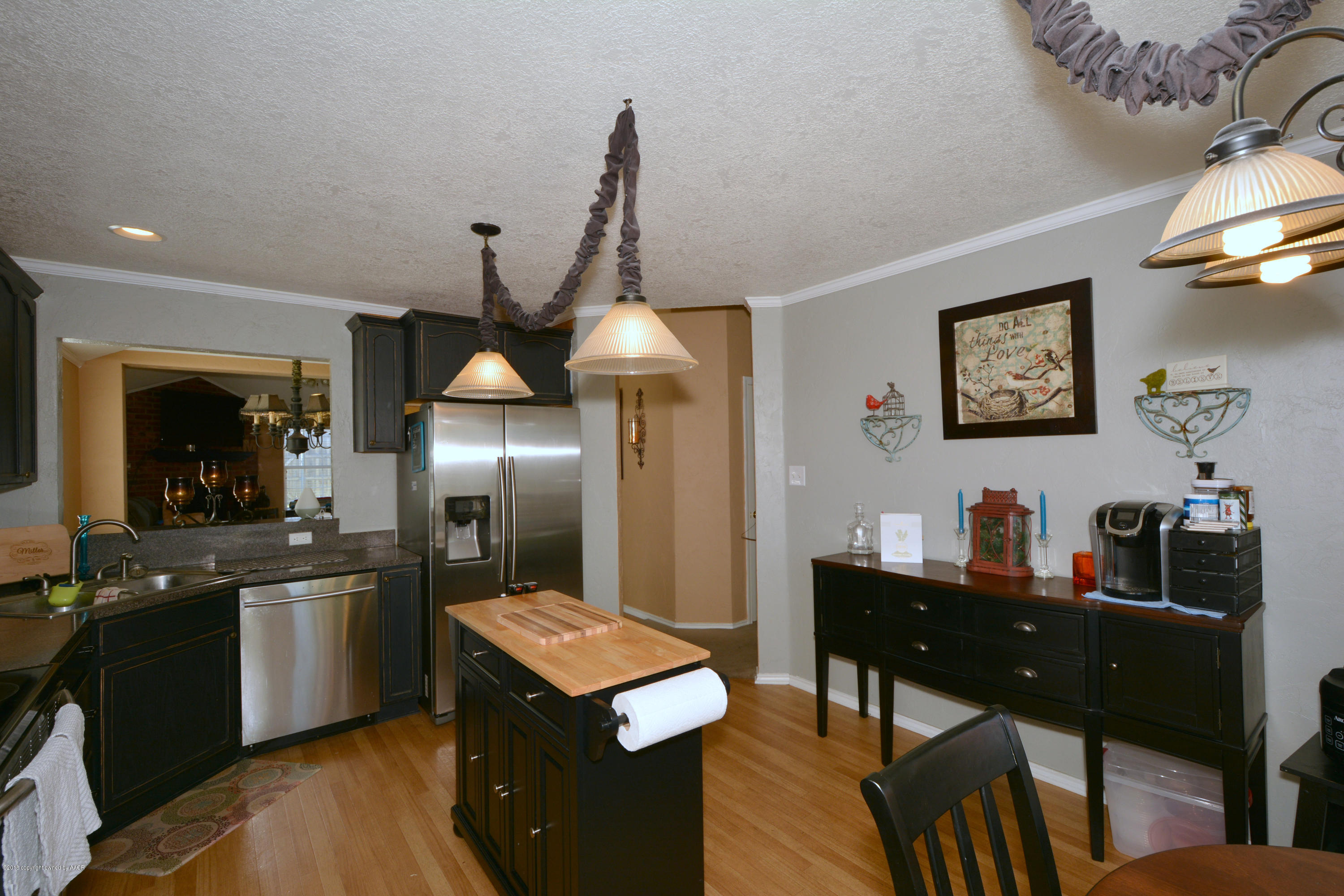 4702 Capulin Lane Amarillo, TX 79110 - Photo 8 of 24 a kitchen with granite countertop cabinets a dining table and chairs