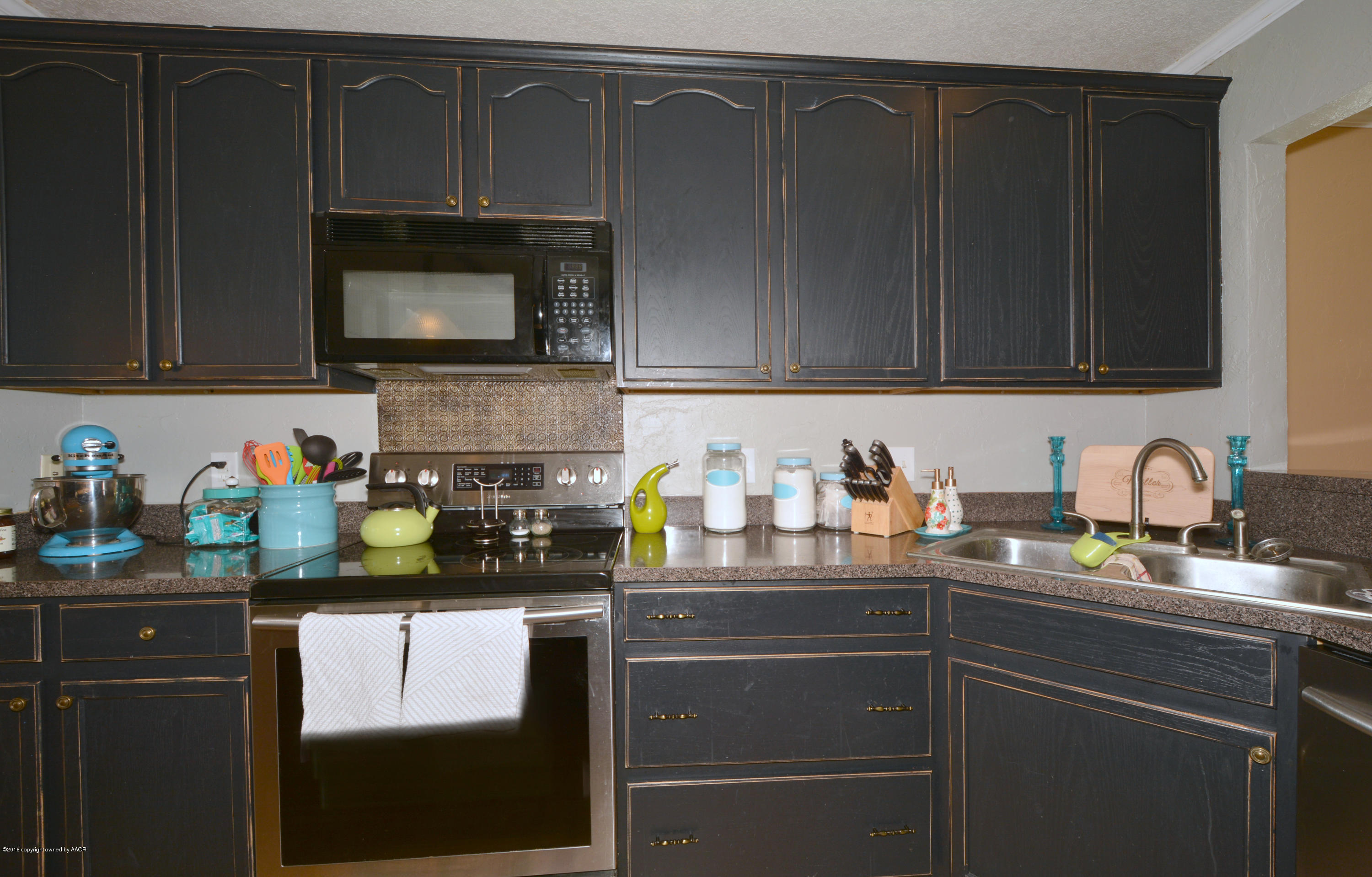 4702 Capulin Lane Amarillo, TX 79110 - Photo 9 of 24 a kitchen with a sink and cabinets