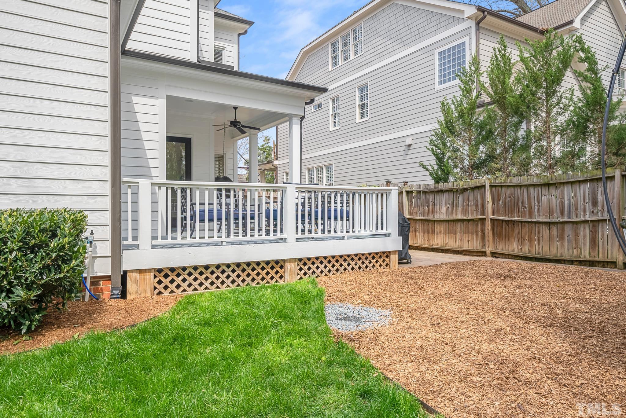2615 Davis Street Raleigh, NC 27608 - Photo 11 of 55 a view of a house with a small yard and wooden fence