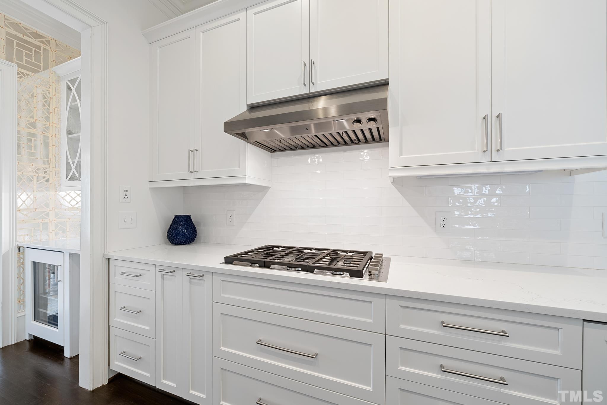 2615 Davis Street Raleigh, NC 27608 - Photo 26 of 55 a kitchen with white cabinets and appliances