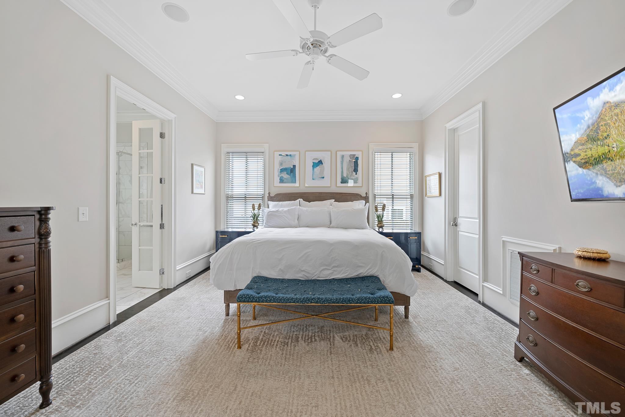 2615 Davis Street Raleigh, NC 27608 - Photo 31 of 55 a spacious bedroom with a bed and a tv