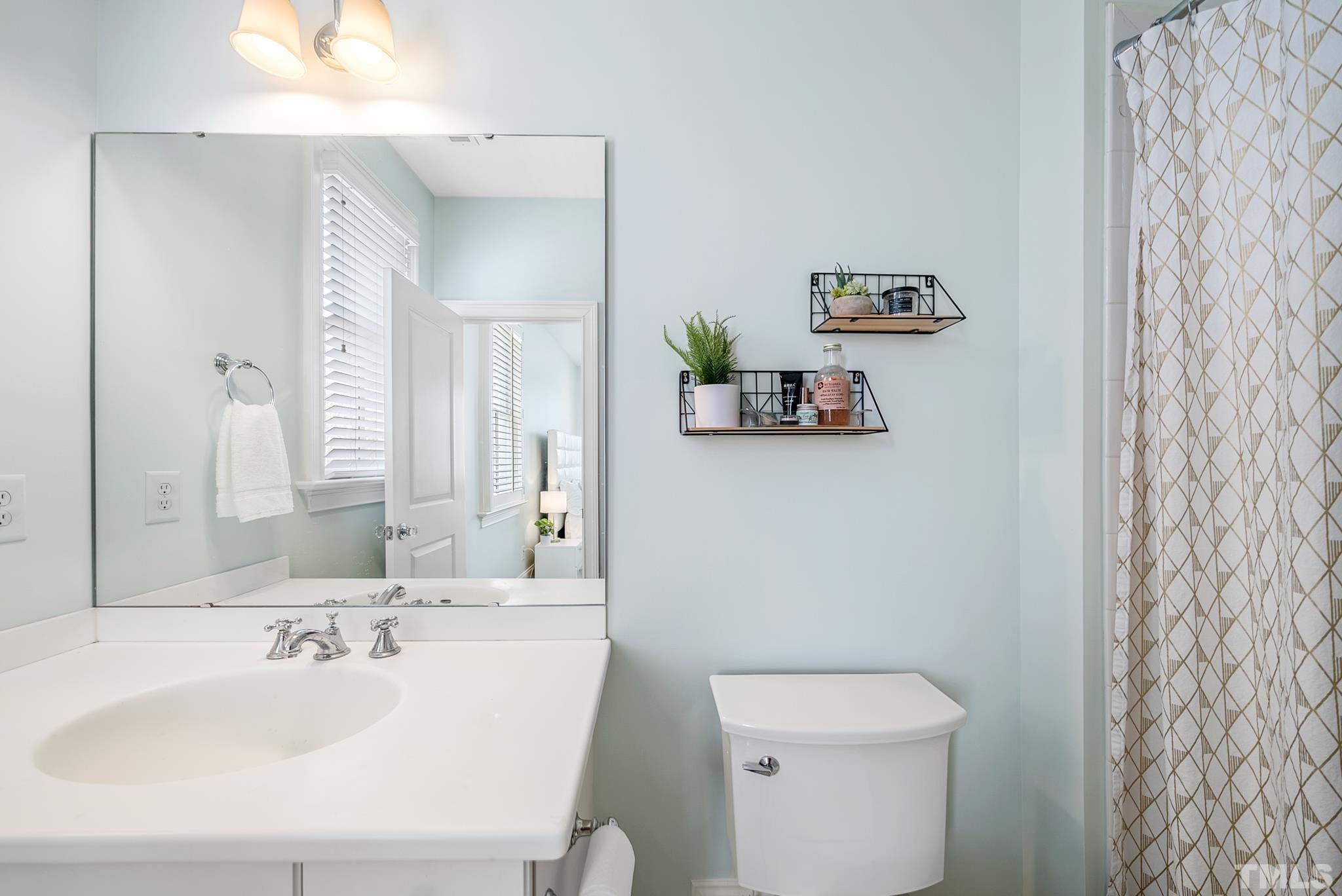 2615 Davis Street Raleigh, NC 27608 - Photo 37 of 55 a bathroom with a sink mirror and toilet