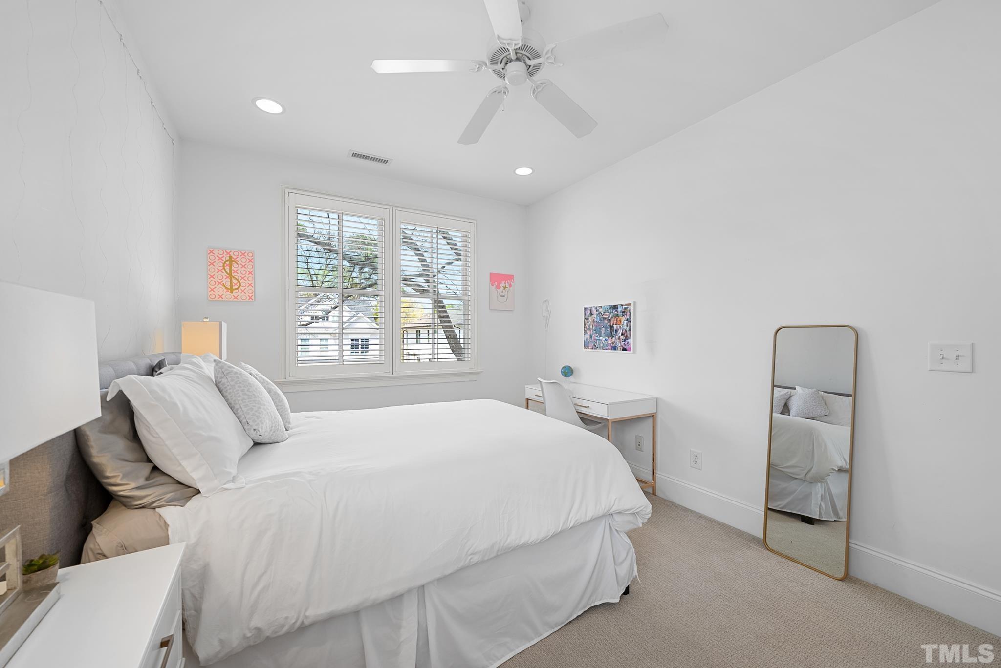 2615 Davis Street Raleigh, NC 27608 - Photo 39 of 55 a bedroom with a large bed and a chandelier