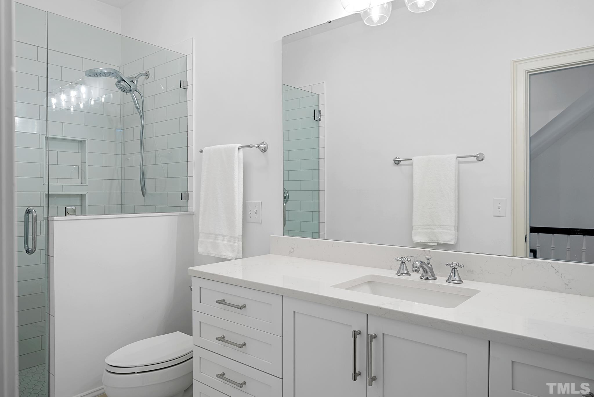 2615 Davis Street Raleigh, NC 27608 - Photo 40 of 55 a bathroom with a granite countertop sink toilet a large mirror and shower