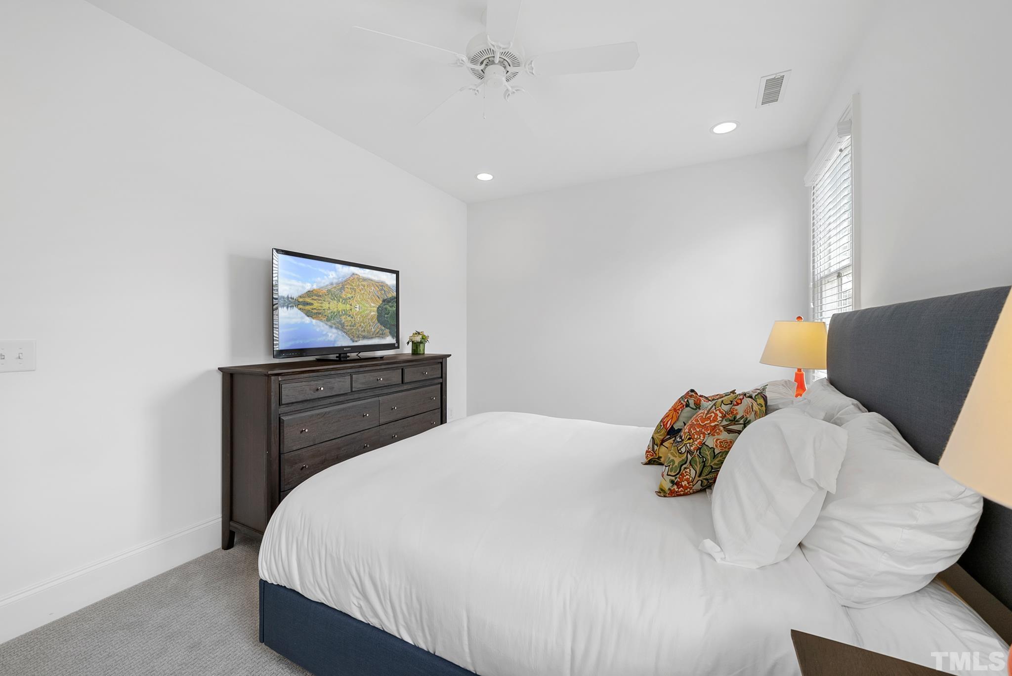 2615 Davis Street Raleigh, NC 27608 - Photo 42 of 55 a bedroom with a bed and a tv