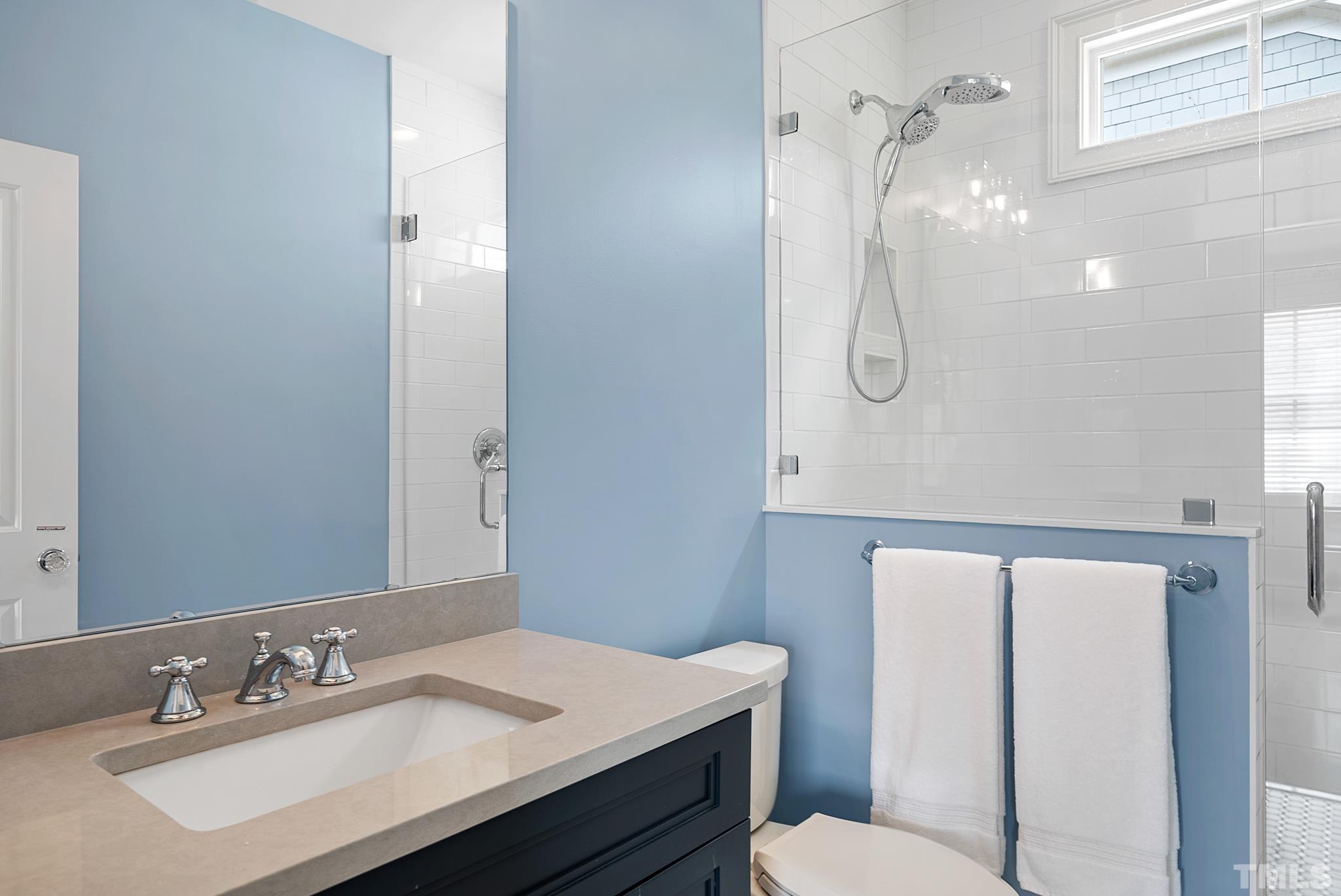 2615 Davis Street Raleigh, NC 27608 - Photo 47 of 55 a bathroom with a sink a toilet and shower