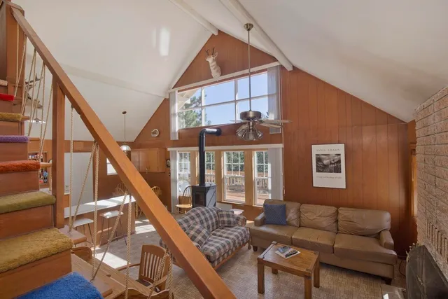 a living room with furniture and stairs