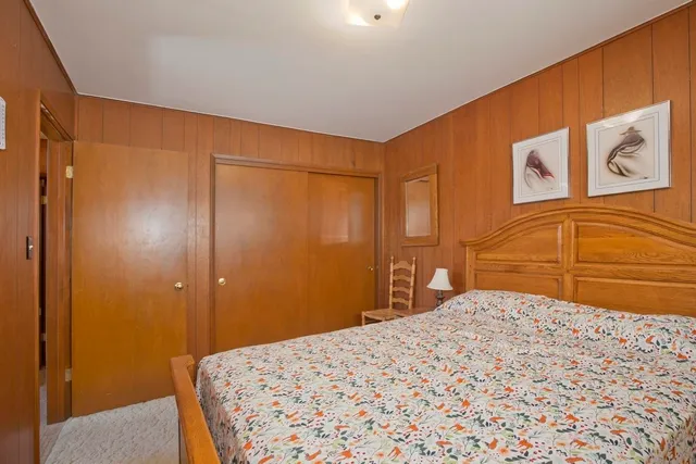 a bedroom with a bed and a mirror