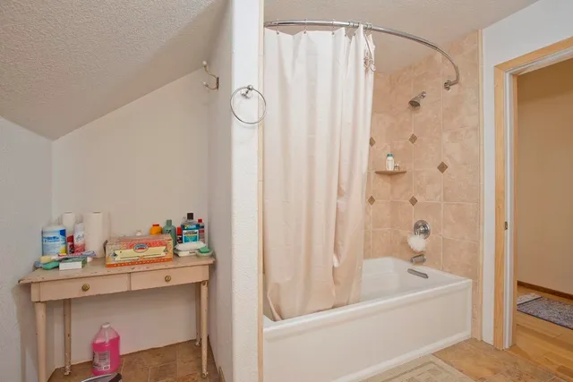 a bathroom with a tub sink and a shower