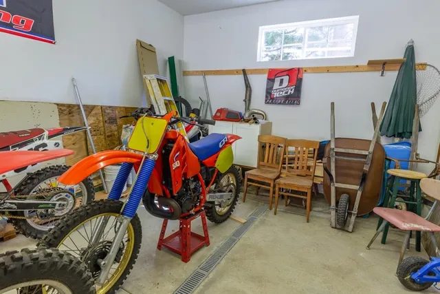 a view of a house with a backyard and a forest