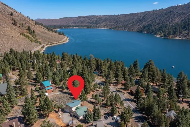 a view of a house with a mountain and mountains in the background