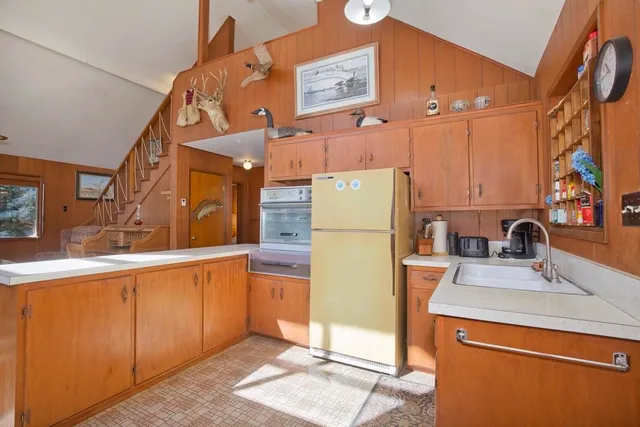 a kitchen that has a sink and a refrigerator