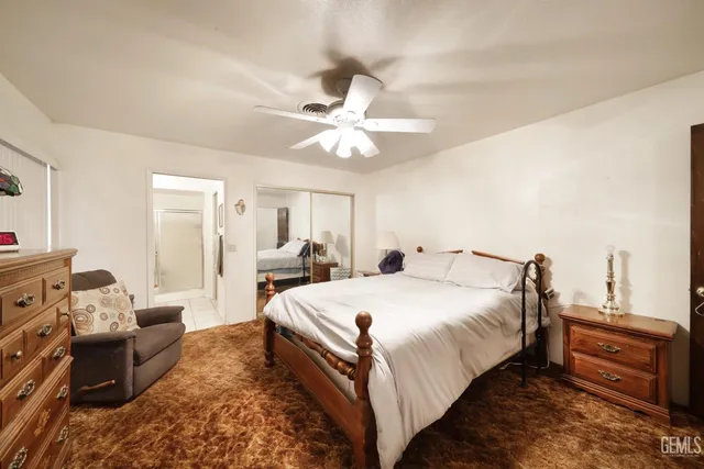 a spacious bedroom with a bed and a chandelier