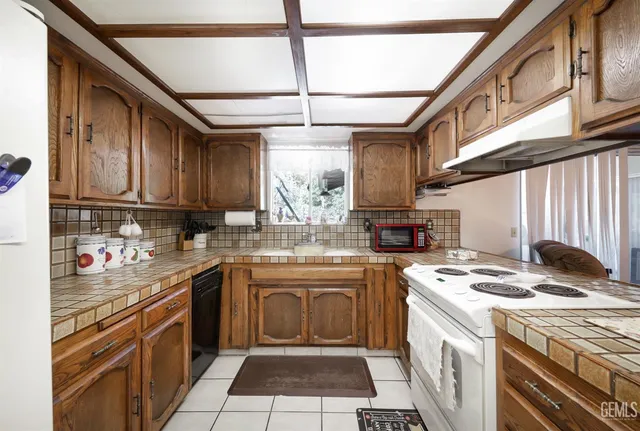 a kitchen with stainless steel appliances granite countertop a stove sink and cabinets