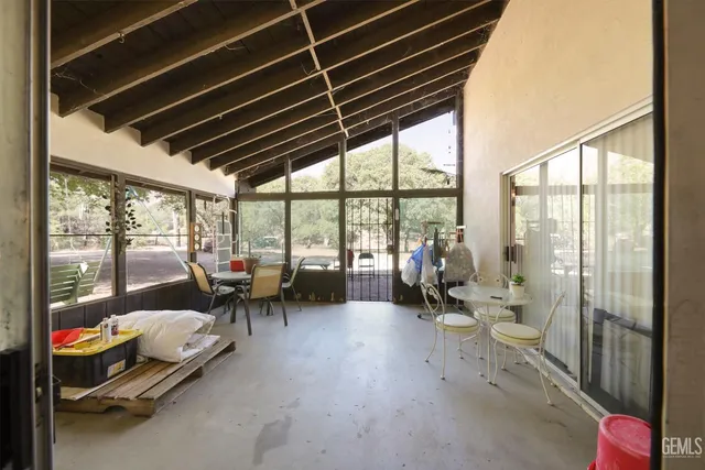 a living room with furniture and floor to ceiling window