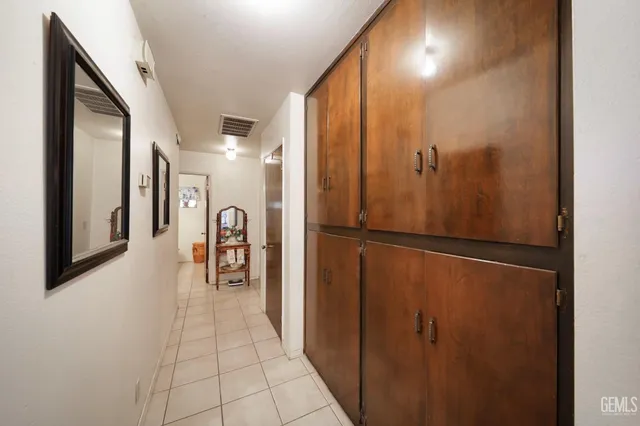 a view of a hallway with a refrigerator
