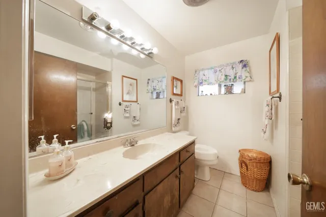 a bathroom with a sink a toilet and mirror