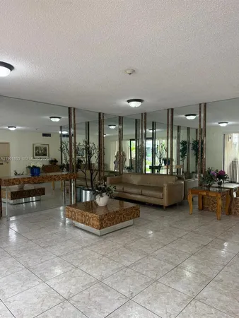 a view of a lobby with furniture and floor to ceiling window
