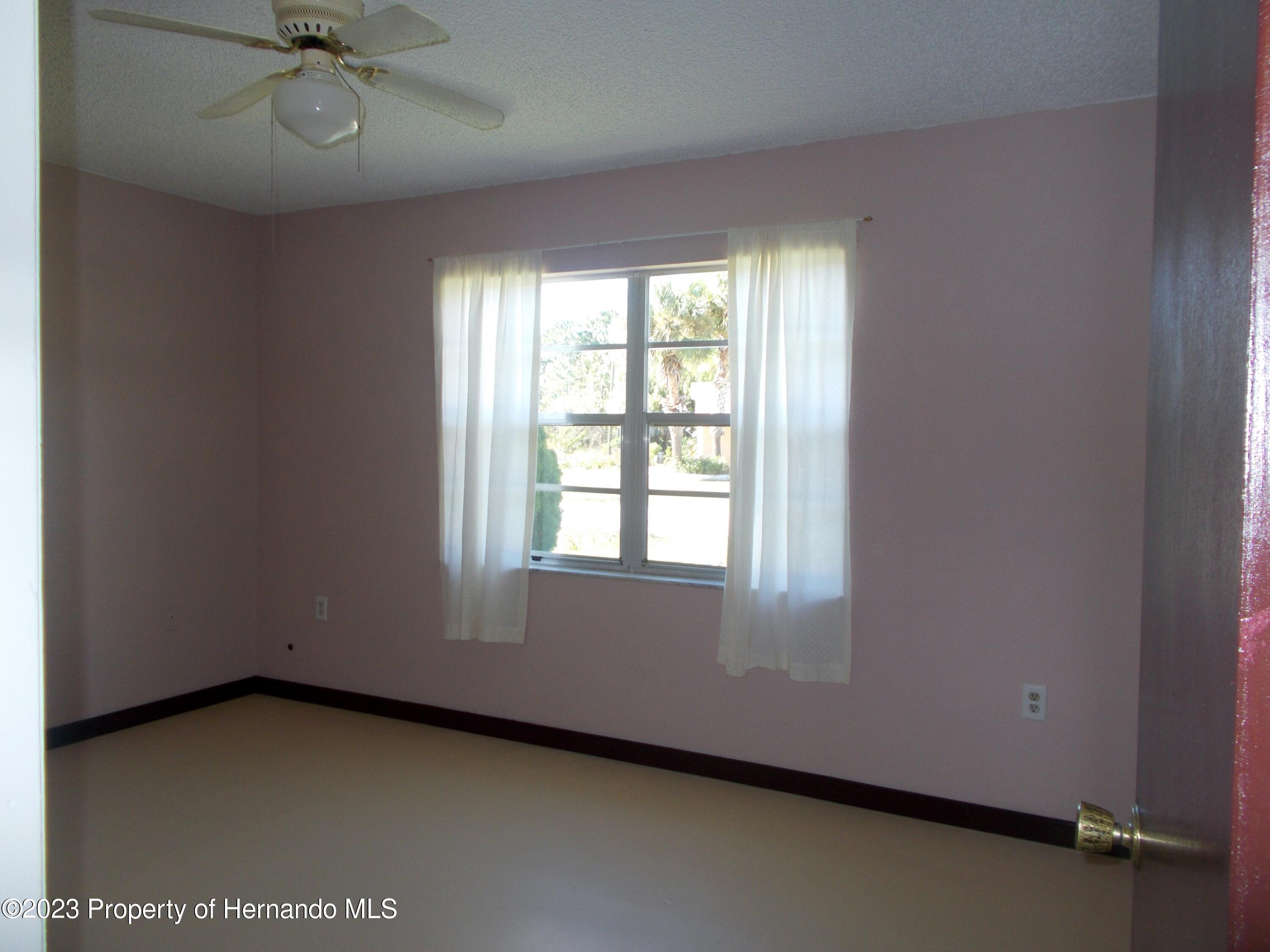 10340 Musa Road Spring Hill, FL 34608 - Photo 8 of 16 an empty room with a window