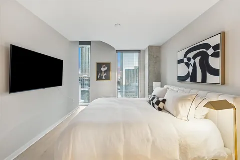 a bedroom with a bed and a flat screen tv