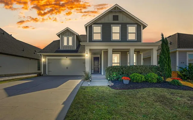 a front view of a house with a yard and outdoor seating