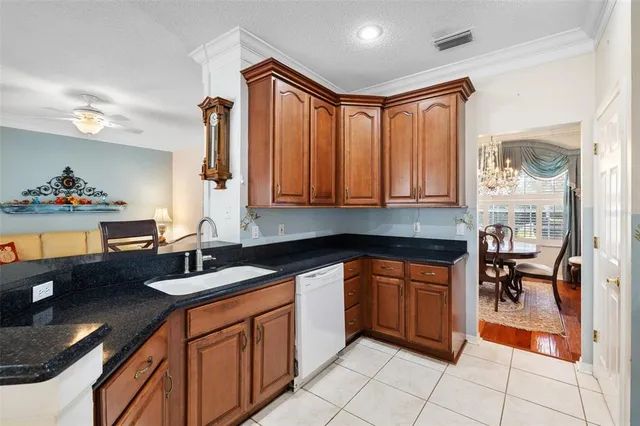 a kitchen with stainless steel appliances granite countertop a sink and cabinets