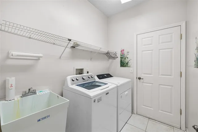 an aerial view of a house with pool table and chairs