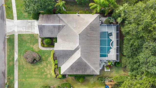 an aerial view of residential houses with outdoor space and swimming pool