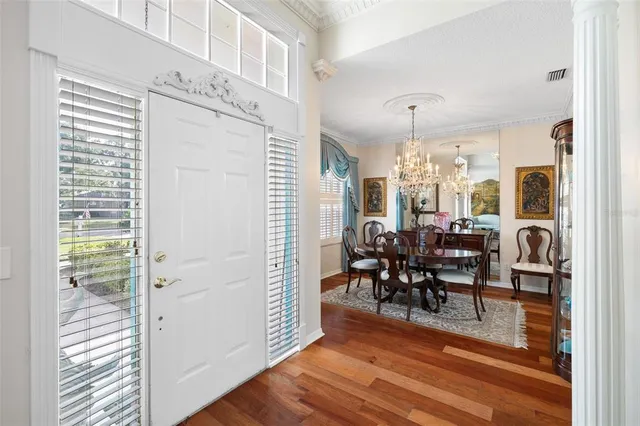 a view of a dining room with furniture and chandelier