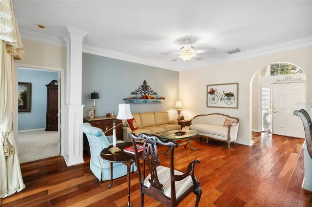 a living room with furniture and wooden floor