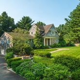 a front view of house with yard and green space