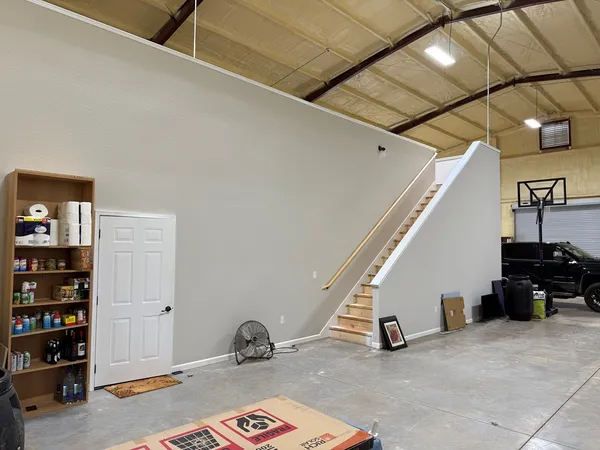 a bed room with a bed and a refrigerator