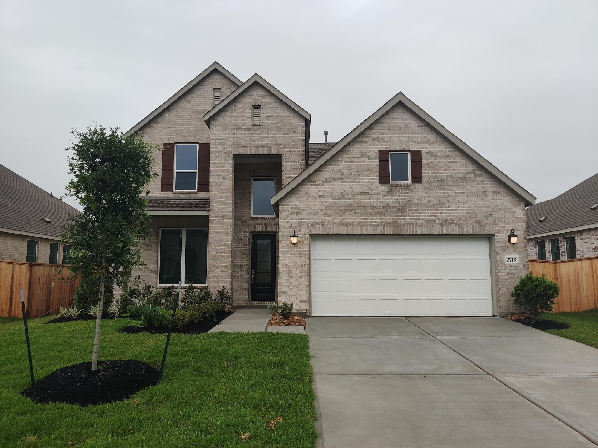 2719 Grove Crest Drive Rosenberg, TX 77469 - Photo 1 of 14 a front view of house with a garden and plants