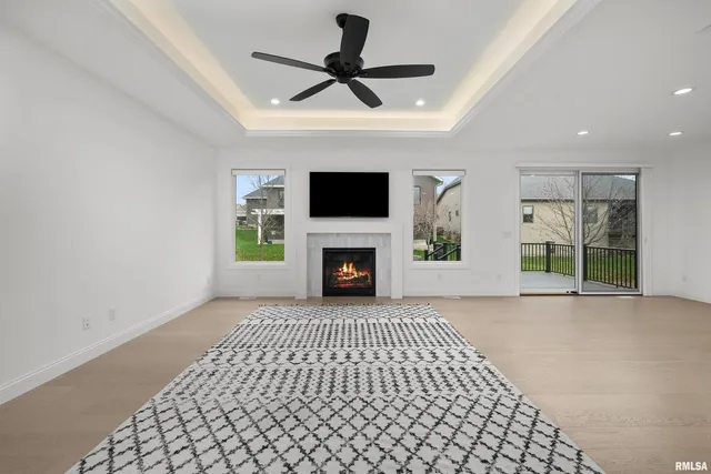 a living room with a fireplace a flat screen tv and a fireplace