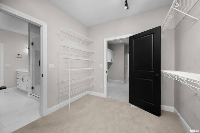 an empty room with a window and a ceiling fan