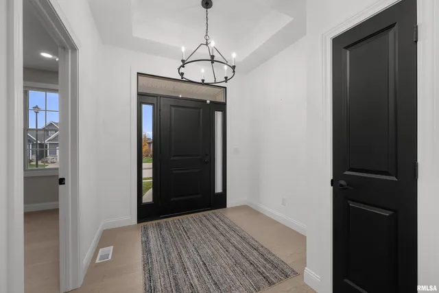a view of a hallway with wooden floor and closet
