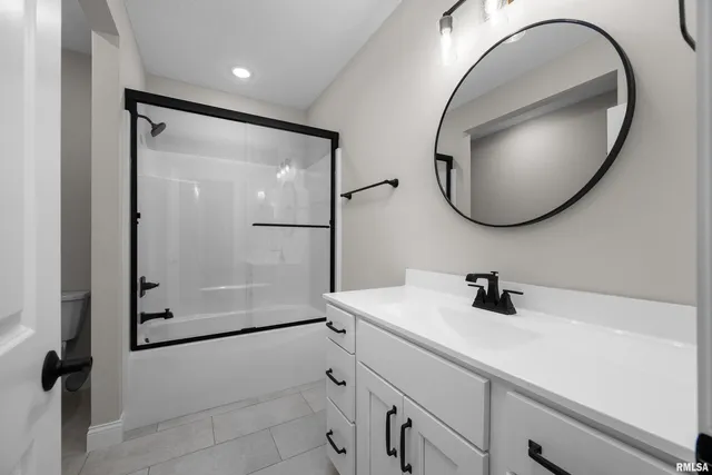 an aerial view of residential houses with outdoor space and parking