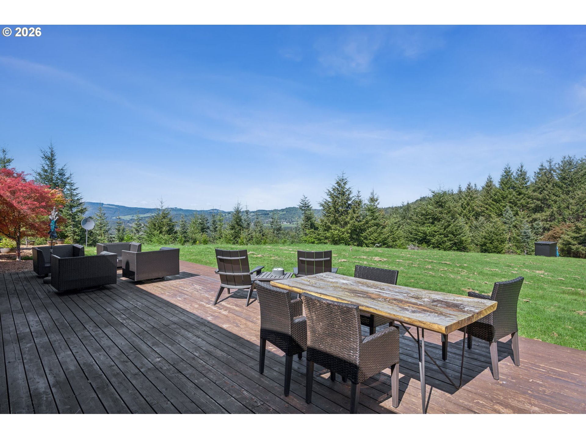 18600 Northwest Meadowlake Road Yamhill, OR 97148 - Photo 29 of 47 a view of a patio with table and chairs with wooden floor and fence