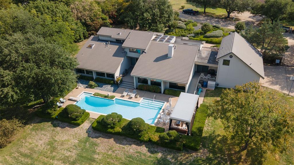 an aerial view of a house with yard swimming pool and outdoor seating