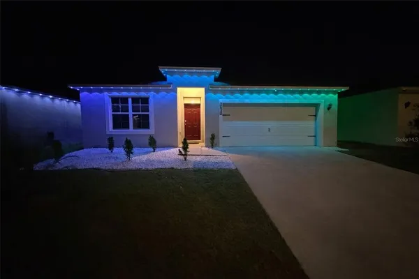 a view of house with backyard and outdoor seating