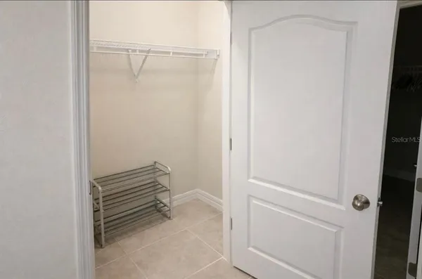 a large bed sitting in a bedroom next to a window