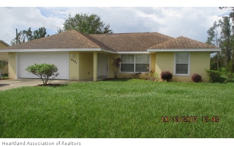 4441 Loquat Road Sebring, FL 33875 - Photo 1 of 6 a view of a yard in front of a house